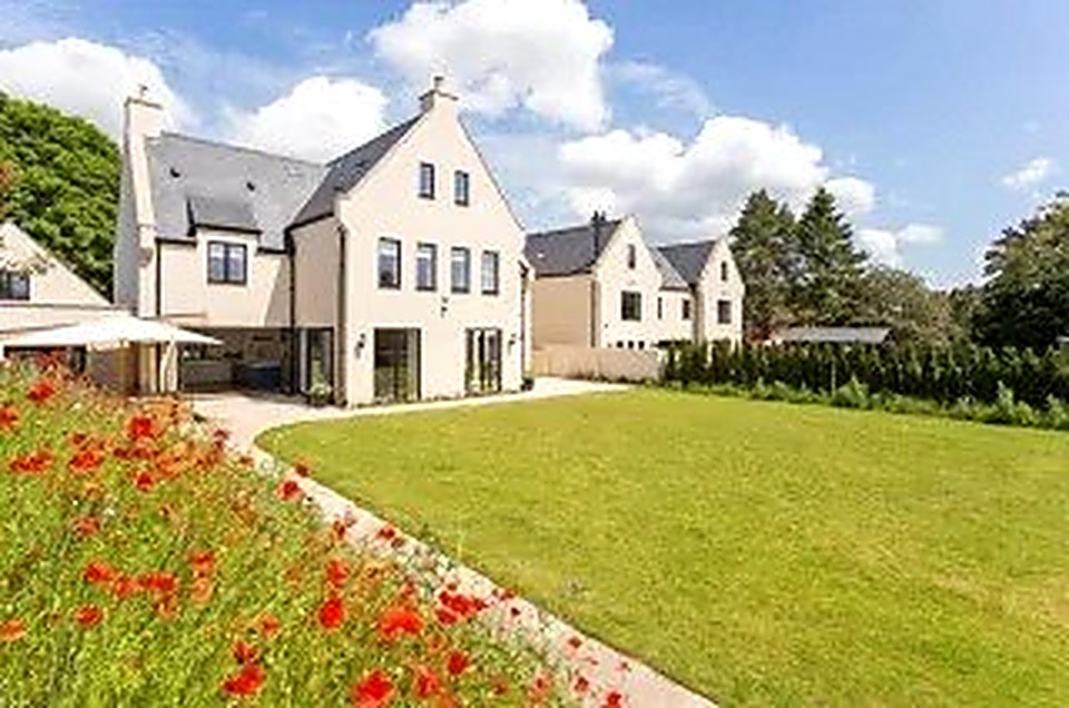 Luxury new build home in Chesterfield with full-height glazing and landscaped lawn, built by Weir Construction Group