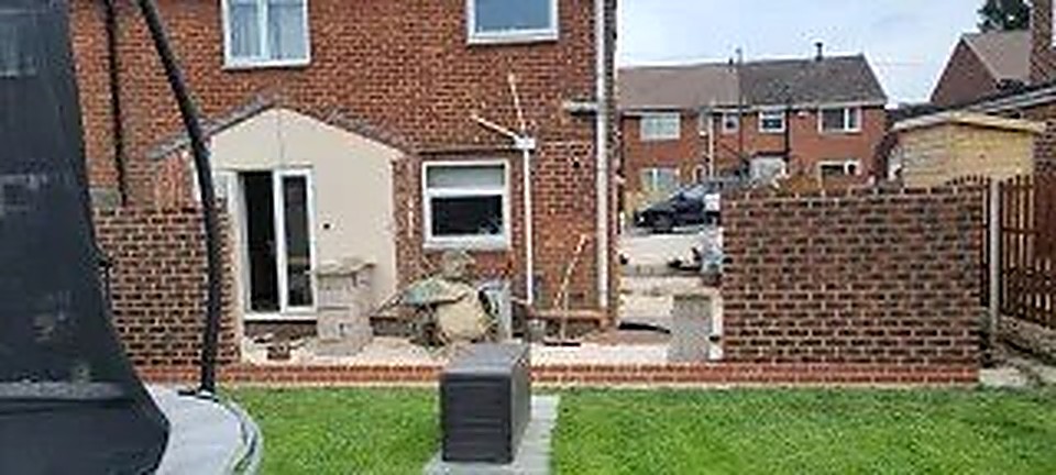 New brick extension walls being raised on a Chesterfield home