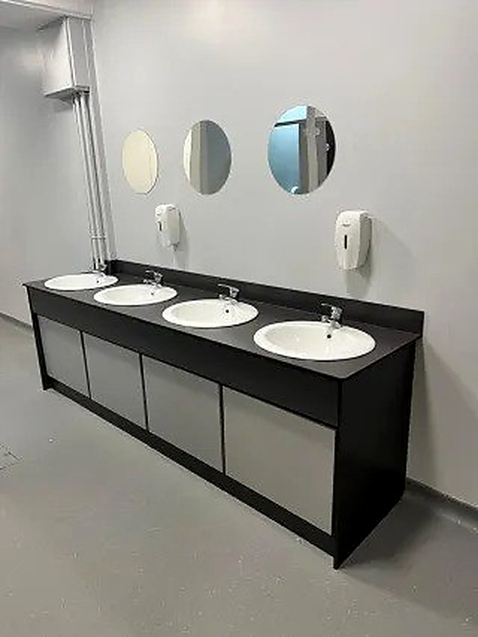 Commercial washroom refurbishment with four sinks and round mirrors, Derbyshire