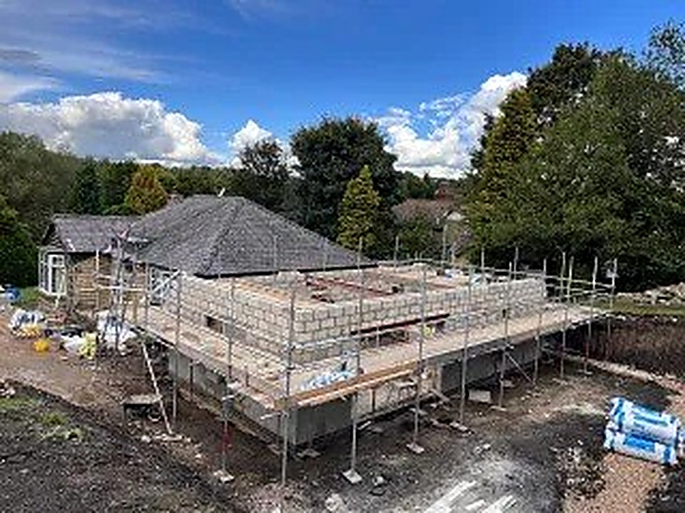 New build brickwork and scaffolding during construction on a Derbyshire building plot