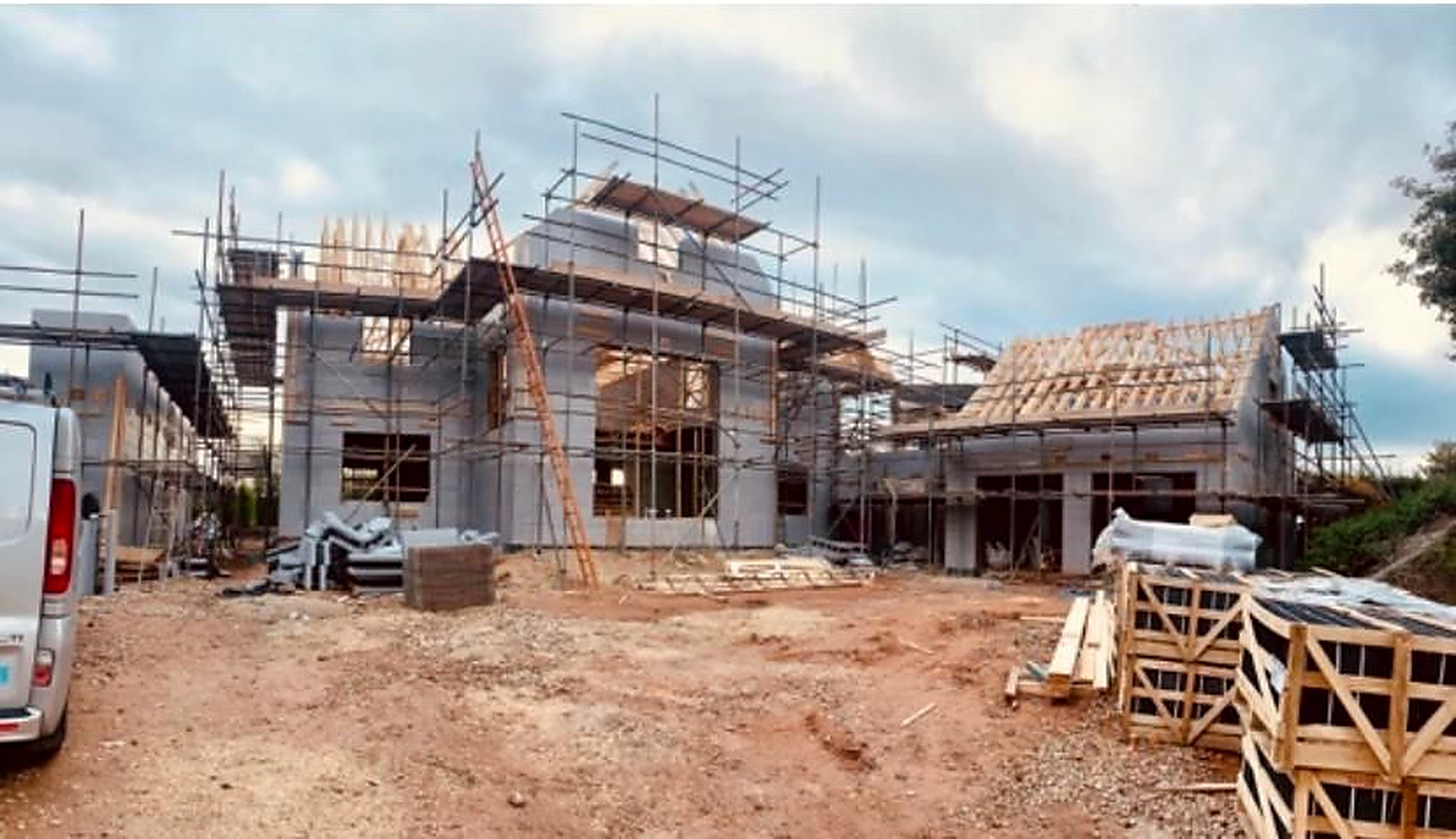 Luxury new build under construction with full scaffolding and new roof trusses, Chesterfield