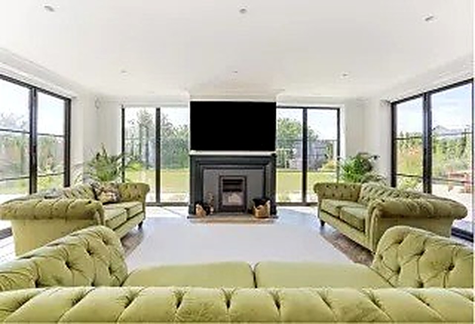 Architect-designed living room with full-width sliding glass doors onto the garden, built in Derbyshire
