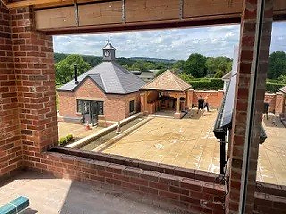 View from inside a new extension through a large window opening onto the patio
