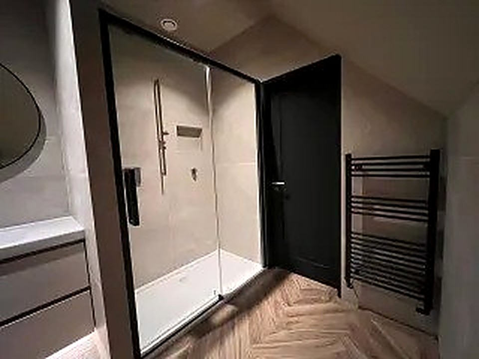 Walk-in shower room and hallway with herringbone flooring in a Chesterfield bathroom renovation