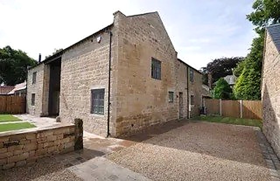 Completed stone barn conversion with grey aluminium windows and gravel driveway, Derbyshire