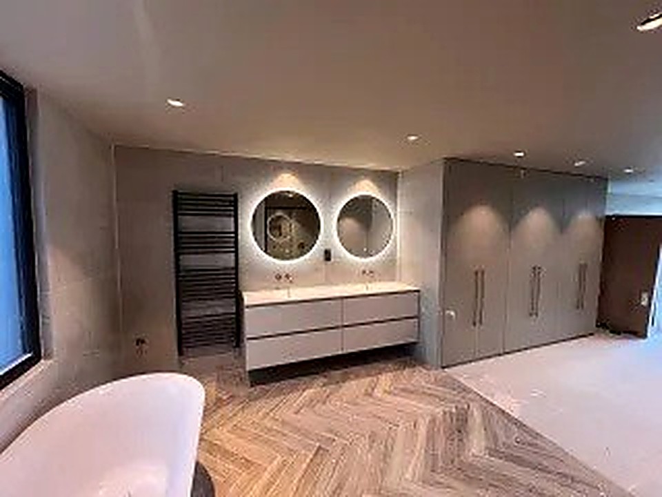 Bathroom renovation with freestanding bath and herringbone wood-effect flooring, Derbyshire