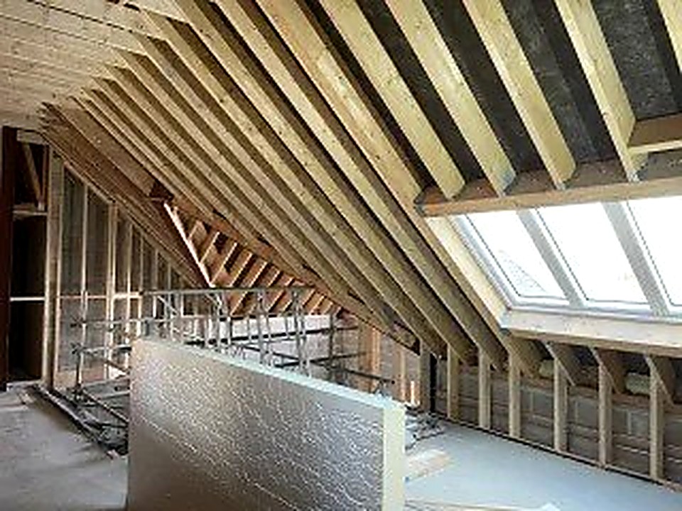 New roof structure from inside showing timber rafters and a large skylight, Chesterfield