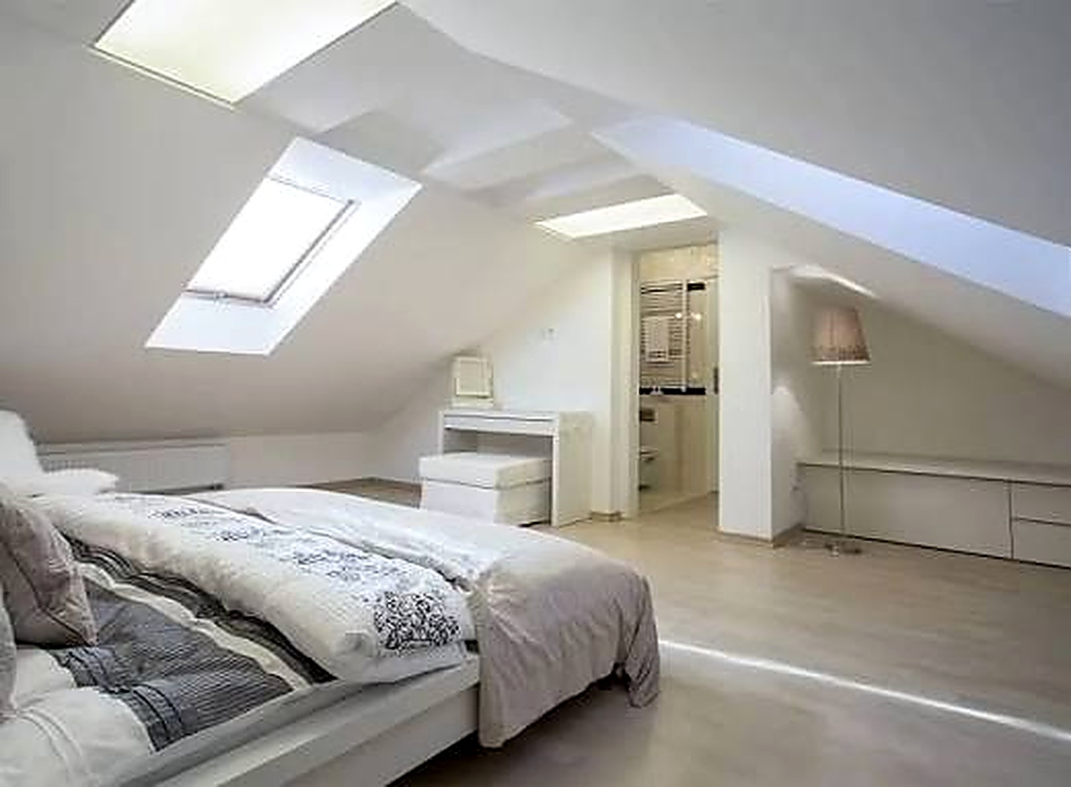 Loft conversion bedroom with sloping ceilings, rooflights and en-suite in Chesterfield