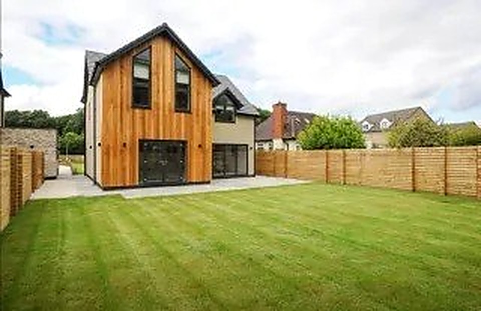 Completed Passive House standard home with timber cladding and lawn in Derbyshire