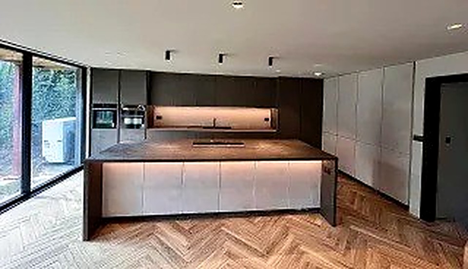 Large kitchen island with under-counter lighting and dark worktop, Derbyshire kitchen renovation